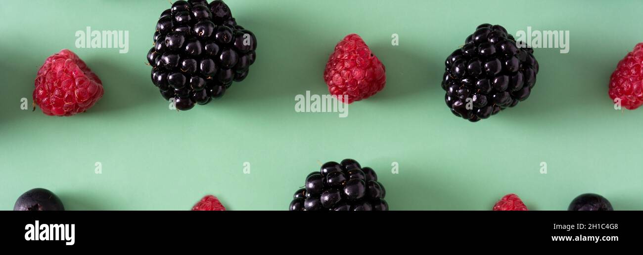 Fresh assortment berries on green background Stock Photo
