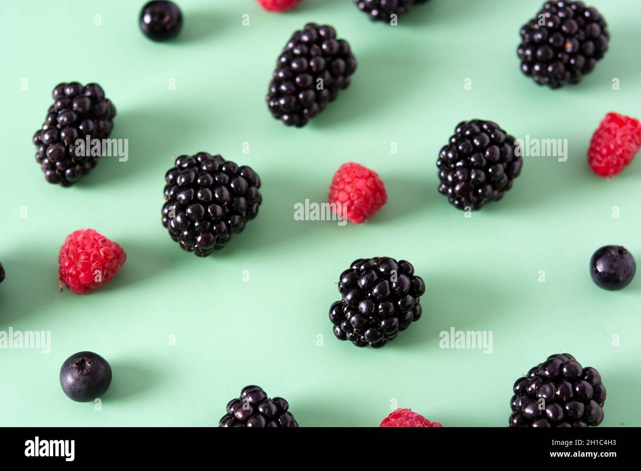 Fresh assortment berries on green background Stock Photo
