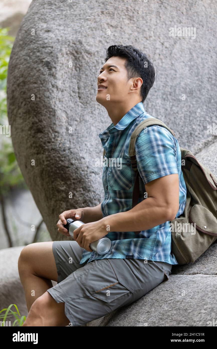 Young man hiking outdoors Stock Photo - Alamy