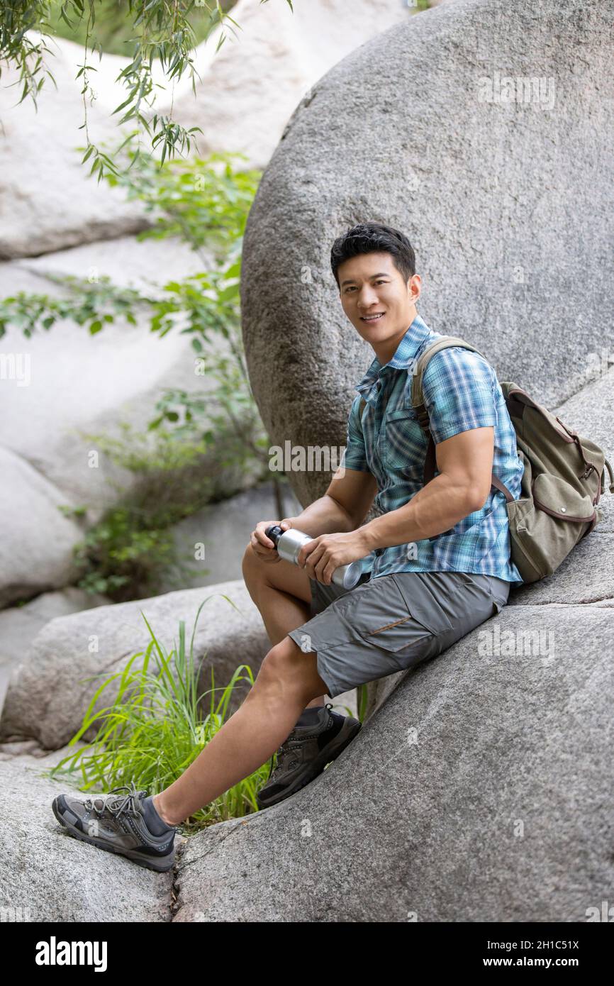 Young man hiking outdoors Stock Photo - Alamy