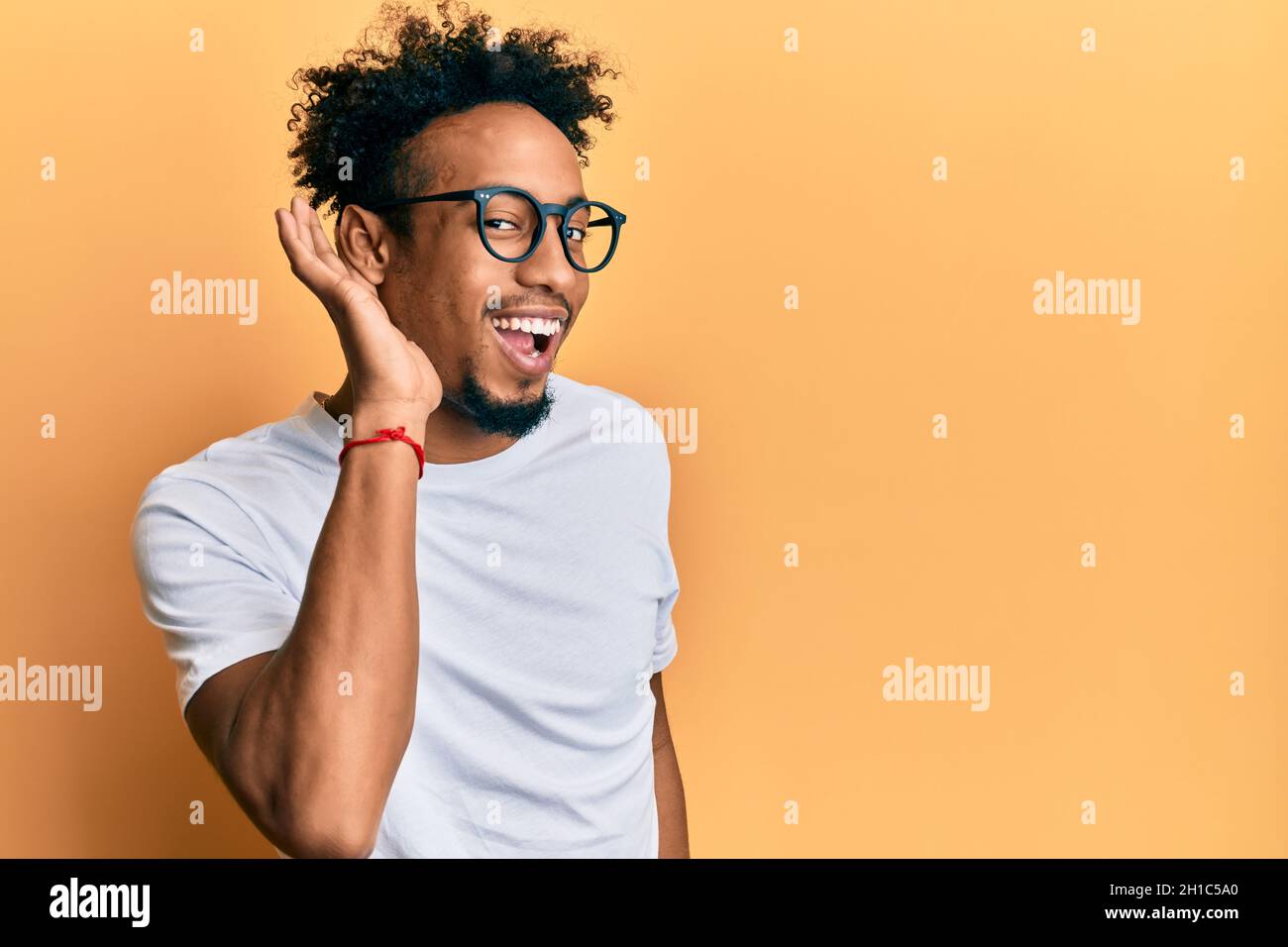 Young african american man with beard wearing casual white t shirt and ...