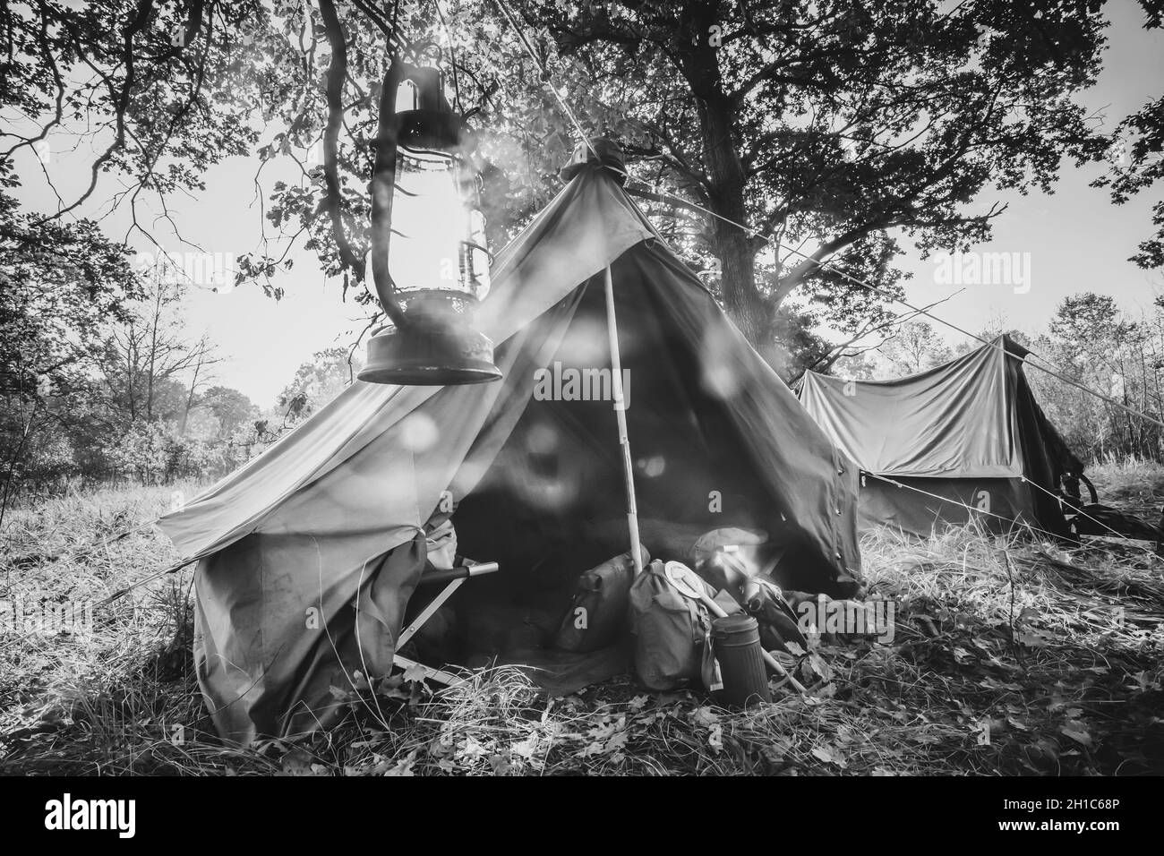 World War II German Wehrmacht Infantry Tent In Forest Camp. WWII WW2 German Ammunition. Photo In Black And White Colors Stock Photo