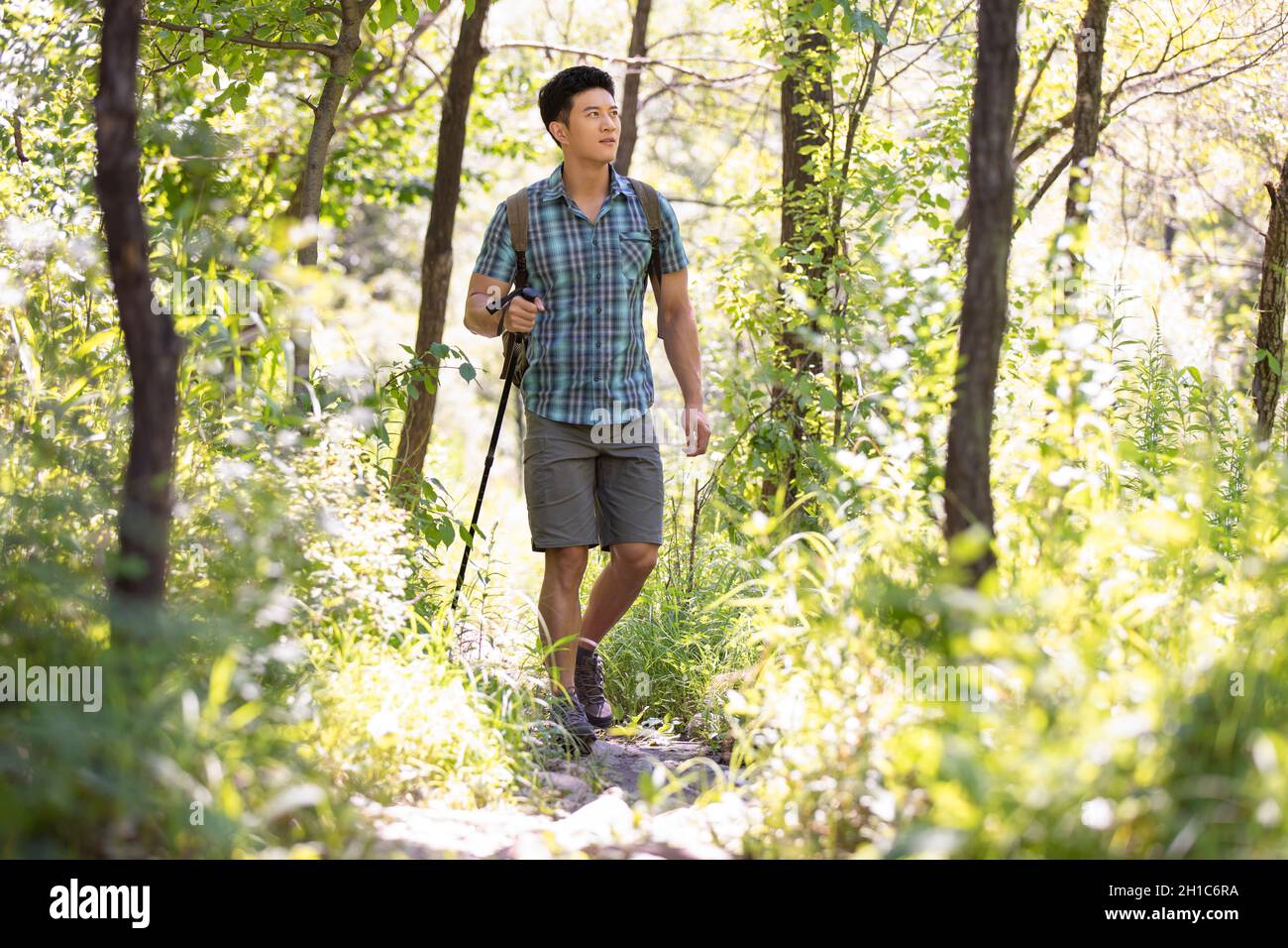 Happy young man hiking outdoors Stock Photo - Alamy