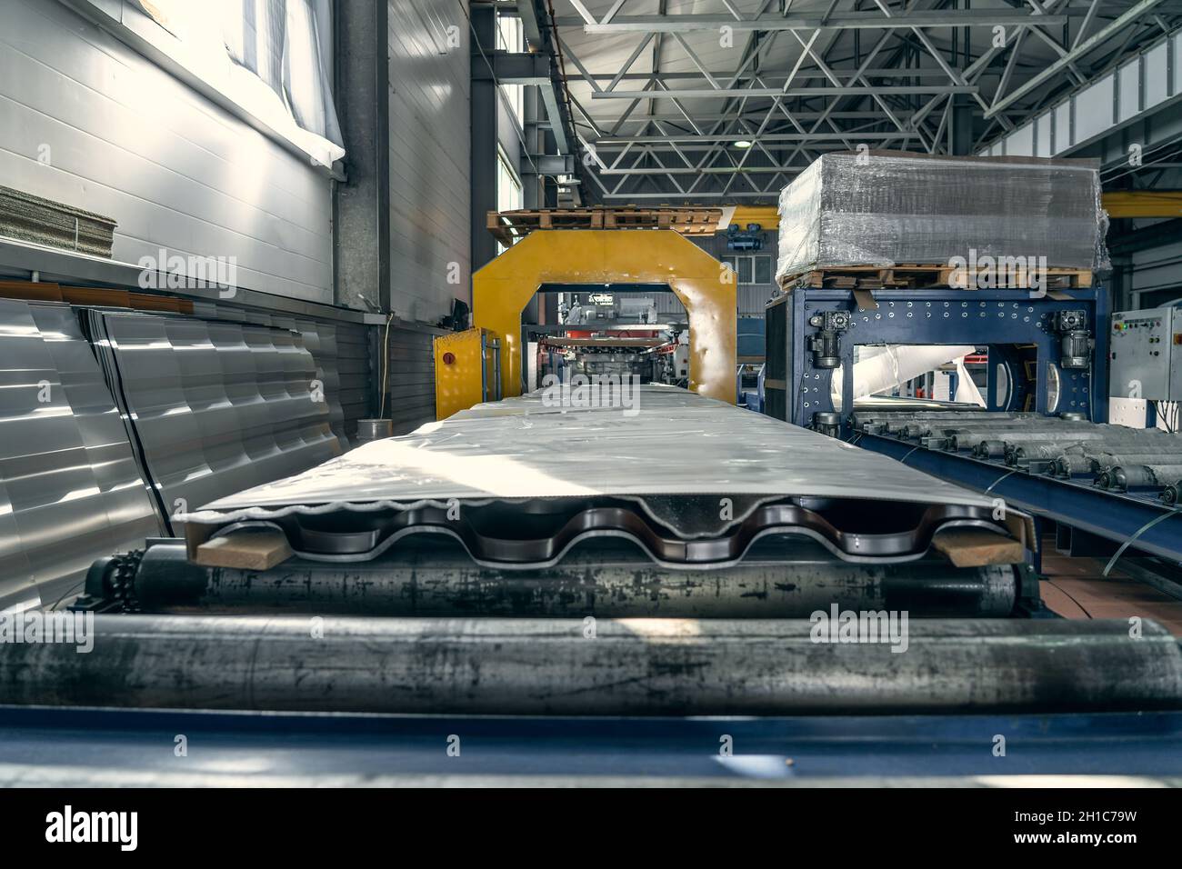 Conveyor belt or line with finished packaged metal roof tiles