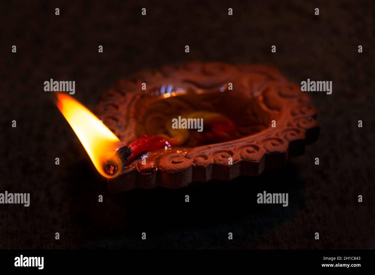 Close-Up Of Diya on black background Stock Photo