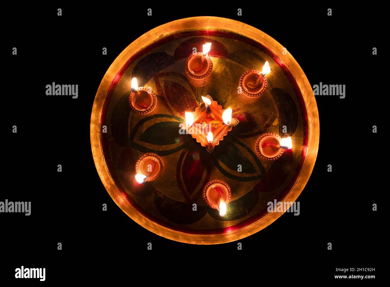 High Angle View Of Lit Diyas In Plate On Floor Stock Photo