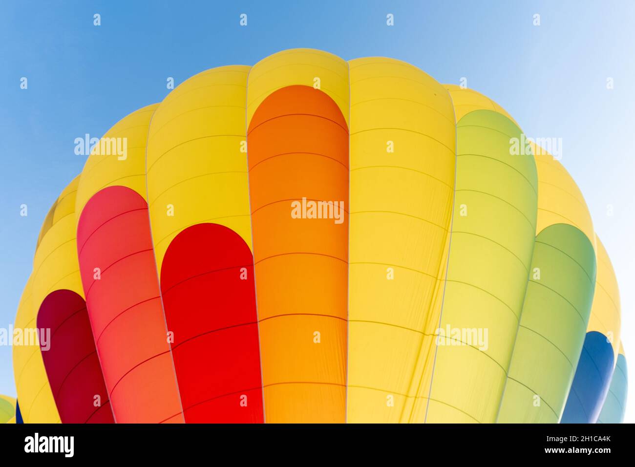 Close-up view of a hot air balloon in green, blue, red and yellow colors Stock Photo