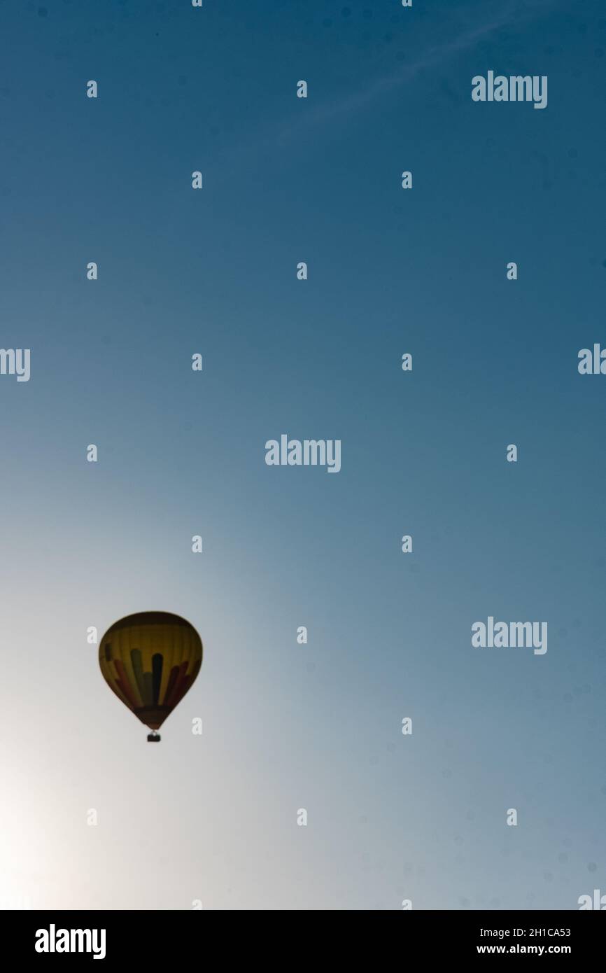 Hot air balloon flying in the blue sky at dawn Stock Photo - Alamy