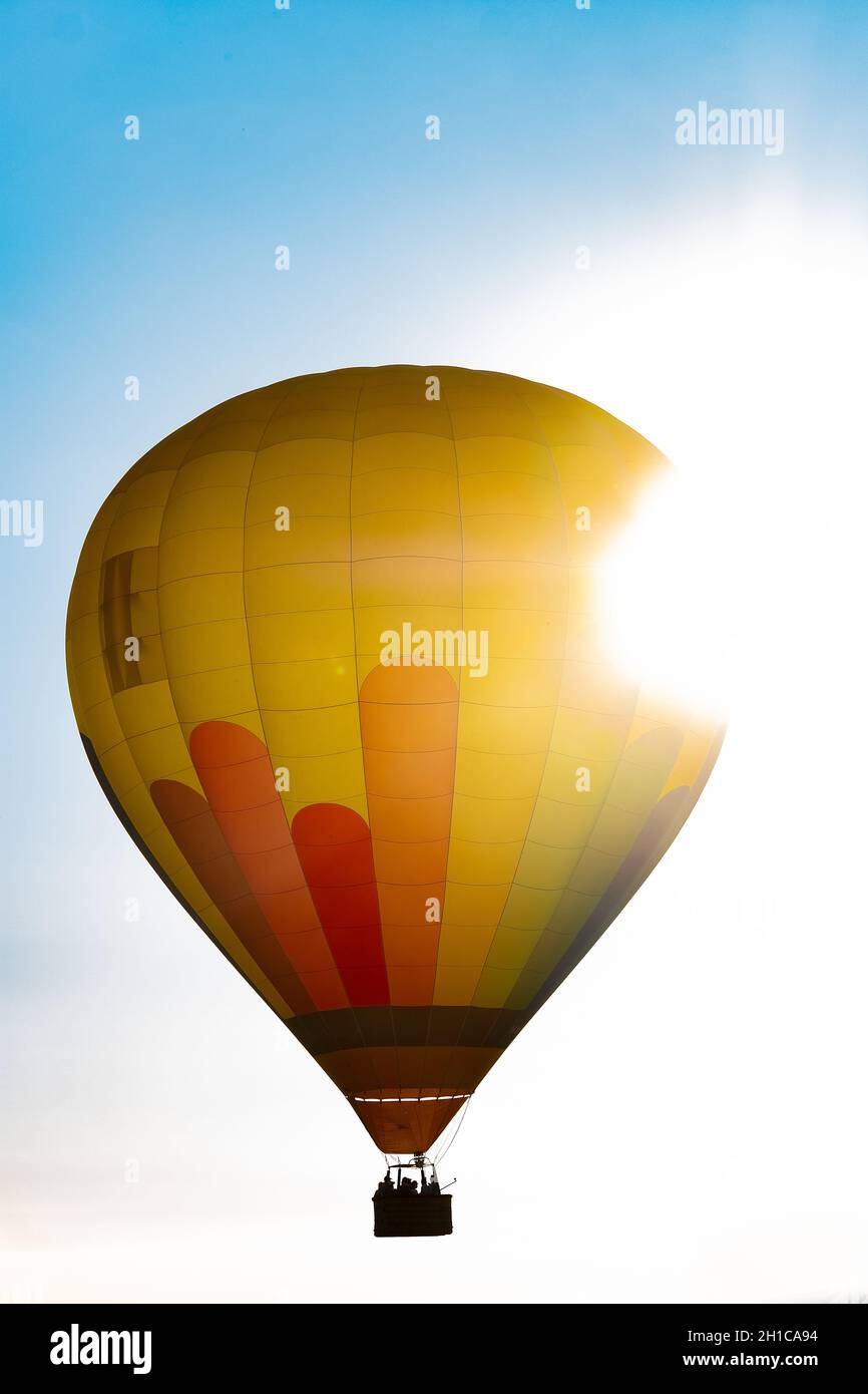 Hot air balloon flying in the blue sky at dawn Stock Photo - Alamy