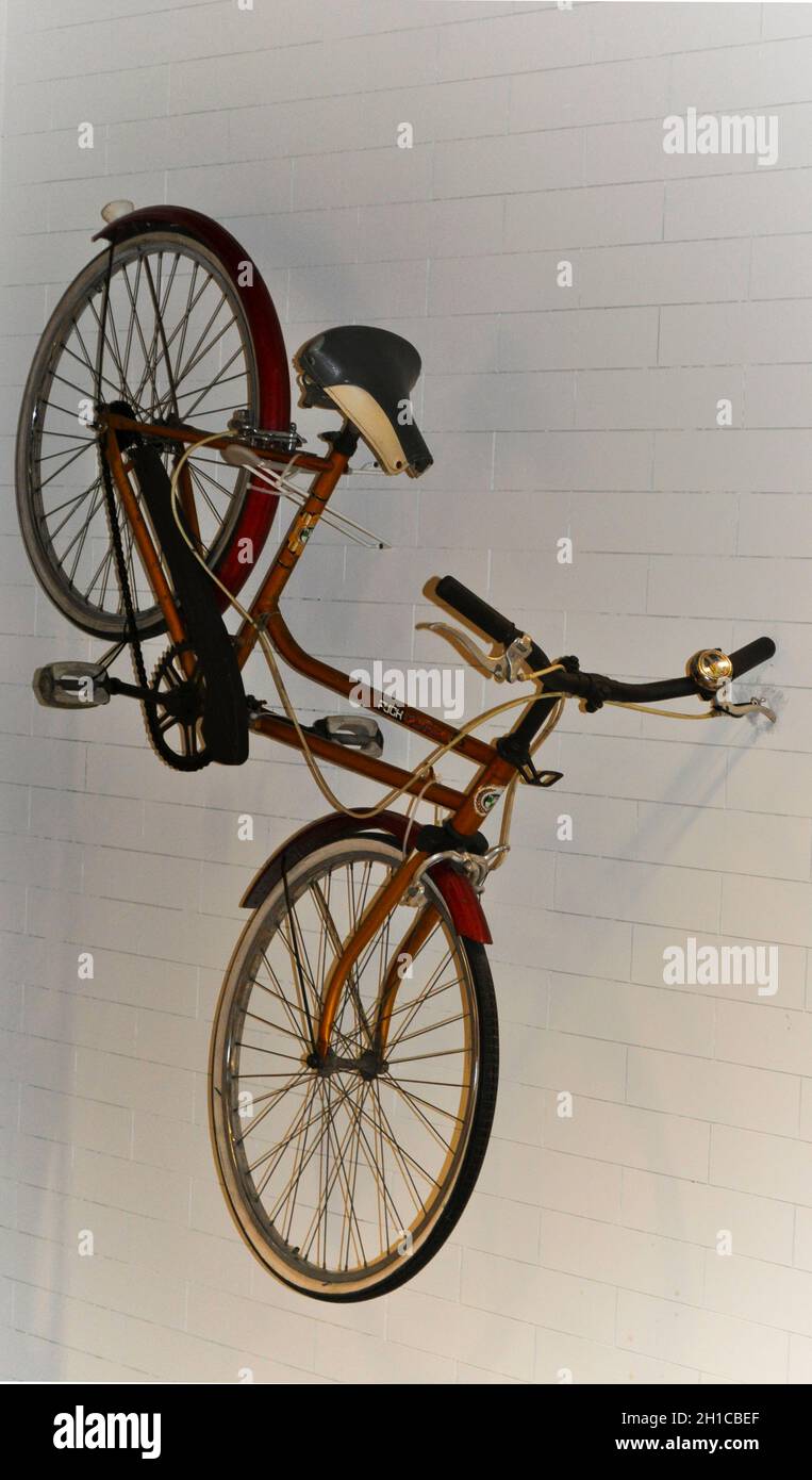 A bicycle mounted to a white tiled wall, IKEA, Sheffield, England Stock Photo