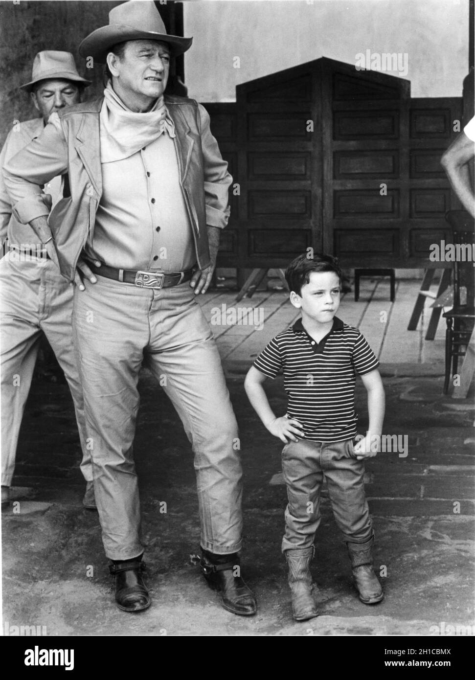 JOHN WAYNE and his 4 year old son JOHN ETHAN on set candid during filming of THE WAR WAGON 1967 director BURT KENNEDY novel / screenplay Clair Huffaker music Dimitri Tiomkin costume design Oscar Rodriguez Batjac Productions / Marvin Schwartz Productions / Universal Pictures Stock Photo