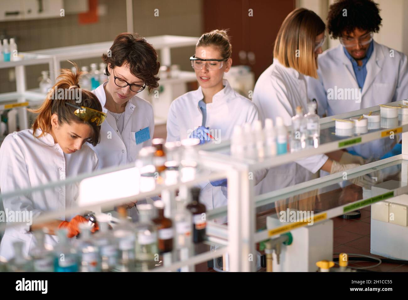 Young students enjoy working in a sterile laboratory environment. Science, chemistry, lab, people Stock Photo