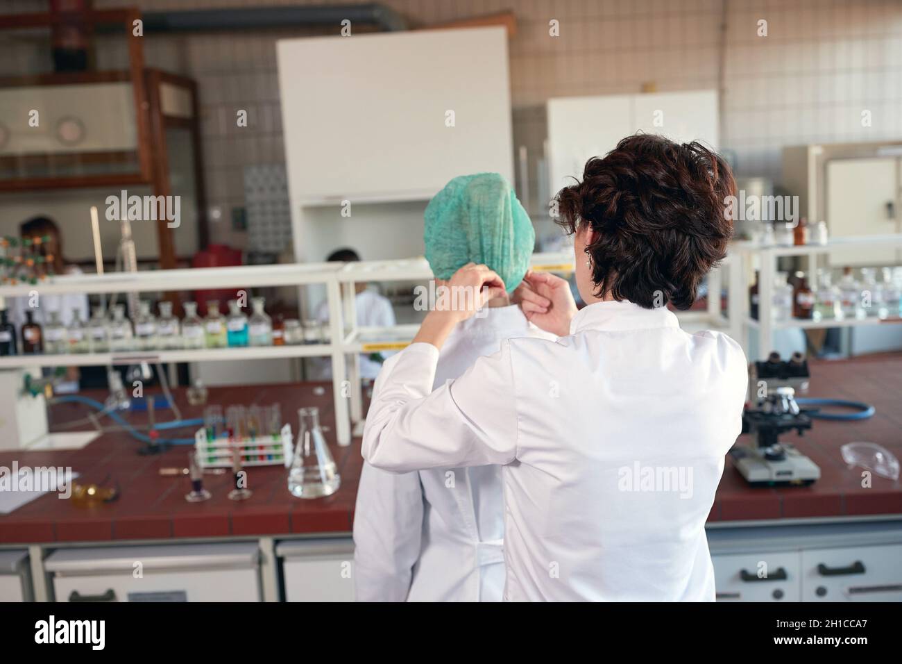 Lab workers in laboratory putting protect cap Stock Photo Alamy