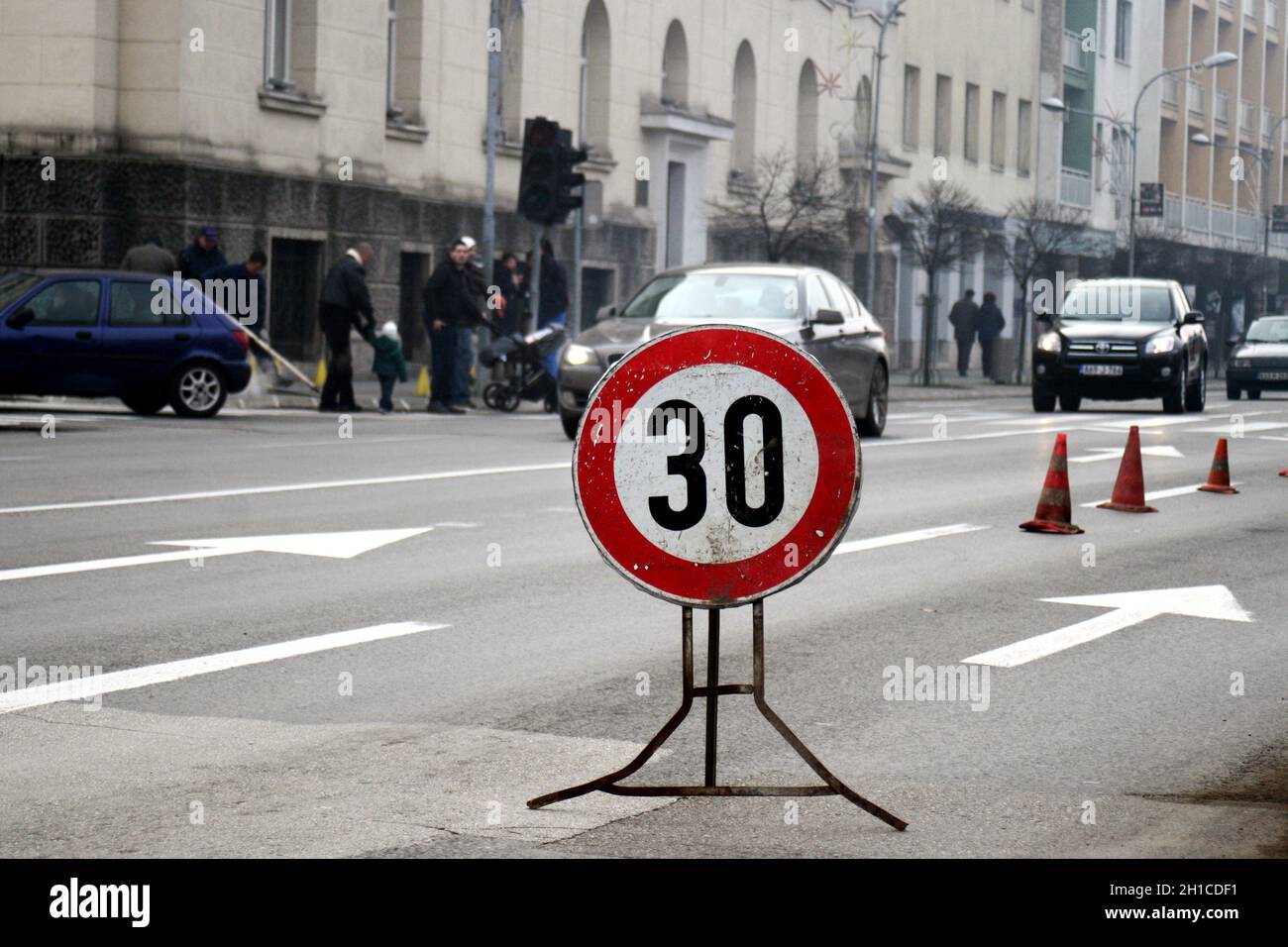 Lower speed of 30 kmh traffic sign in the street Stock Photo