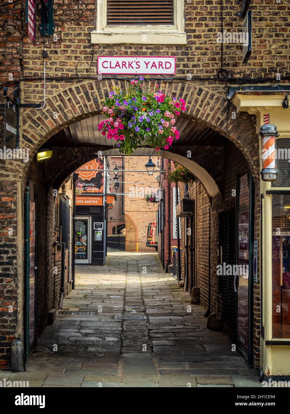 Entrance to Clark's Yard, one of three narrow alleys connecting Skinnergate to High Row in Darlington's town centre Stock Photo