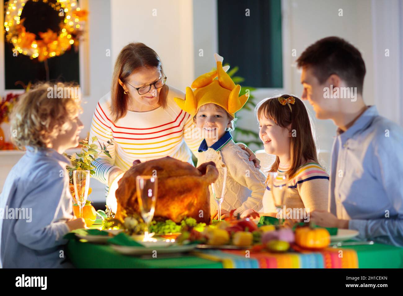 Family at Thanksgiving dinner. Parents, grandparents and kids enjoy