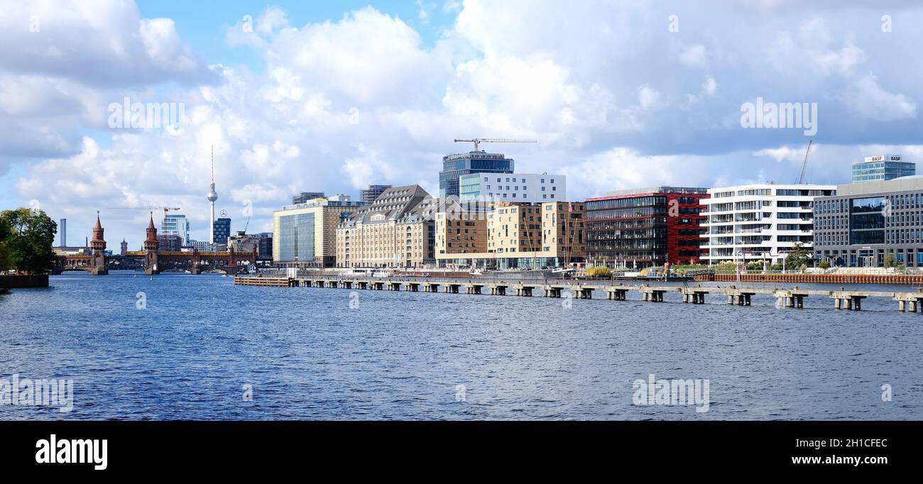 Berlin, Germany, October 13, 2021, view over the river Spree to the skyline of the city center with TV tower, Oberbaumbrücke, warehouse and town house Stock Photo