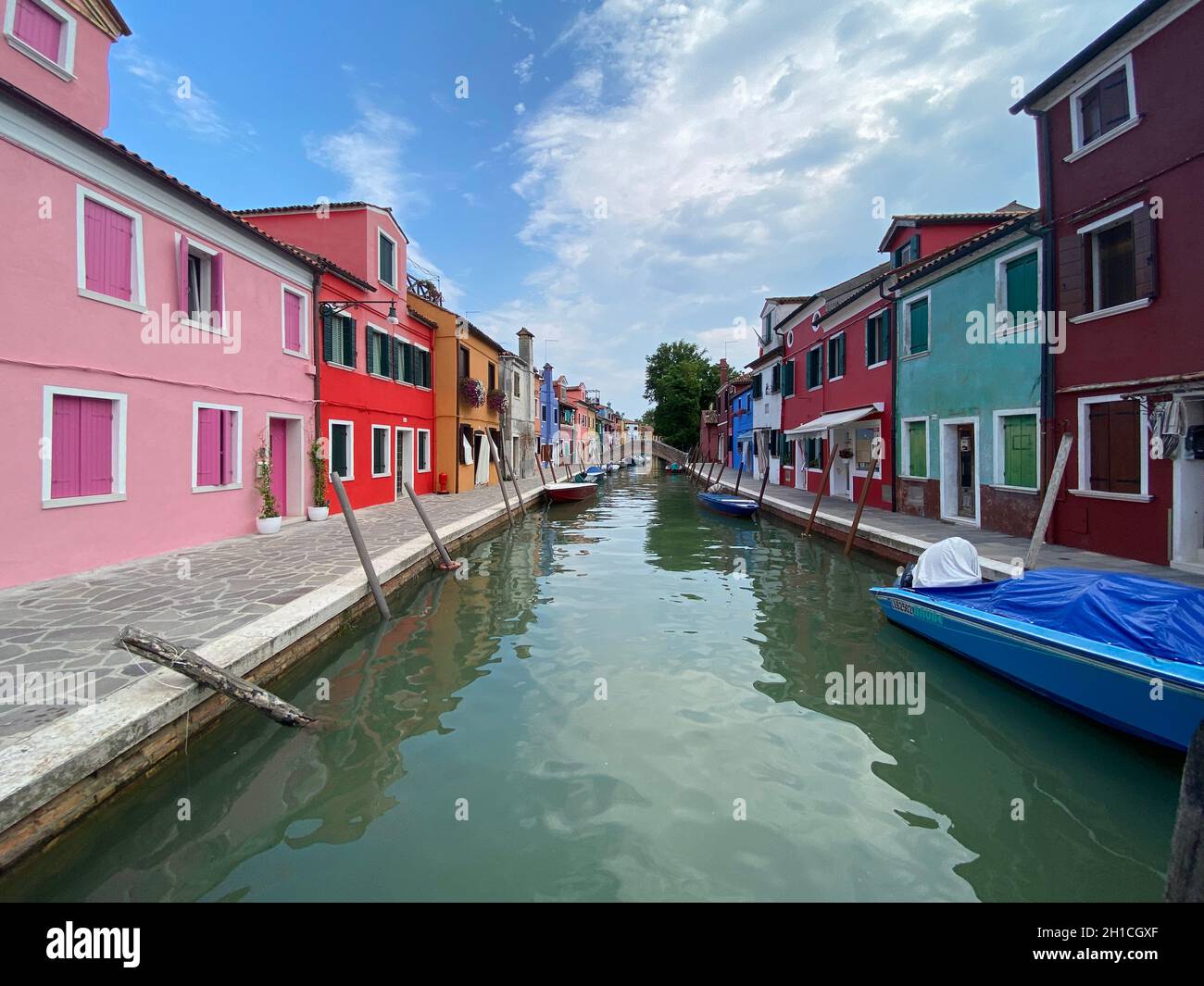 Boats and colorful traditional painted houses in a canal street houses ...