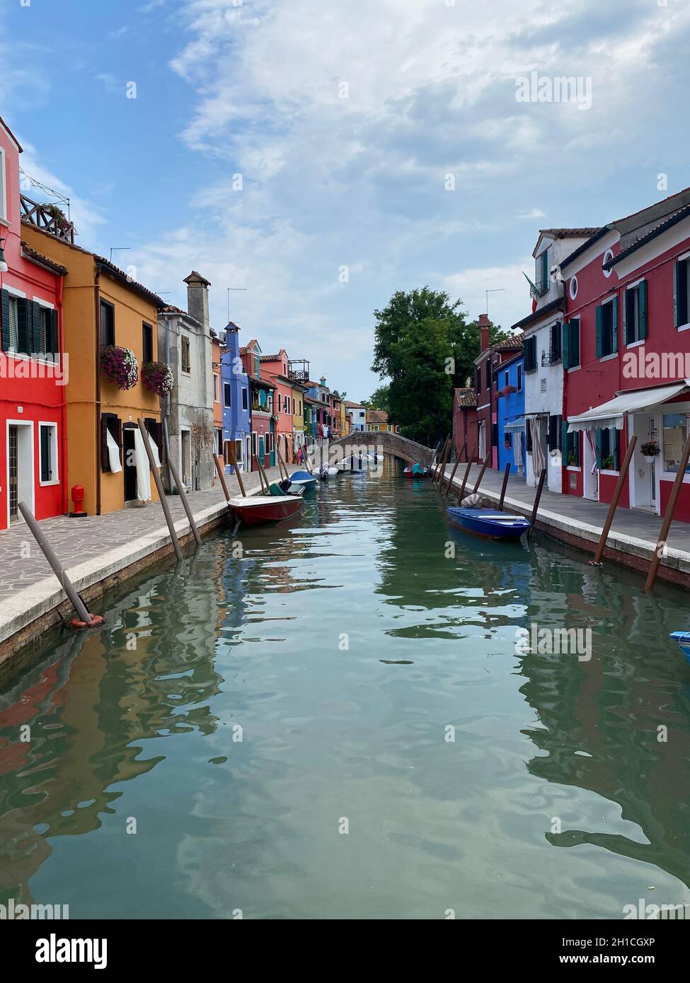 Boats and colorful traditional painted houses in a canal street houses ...