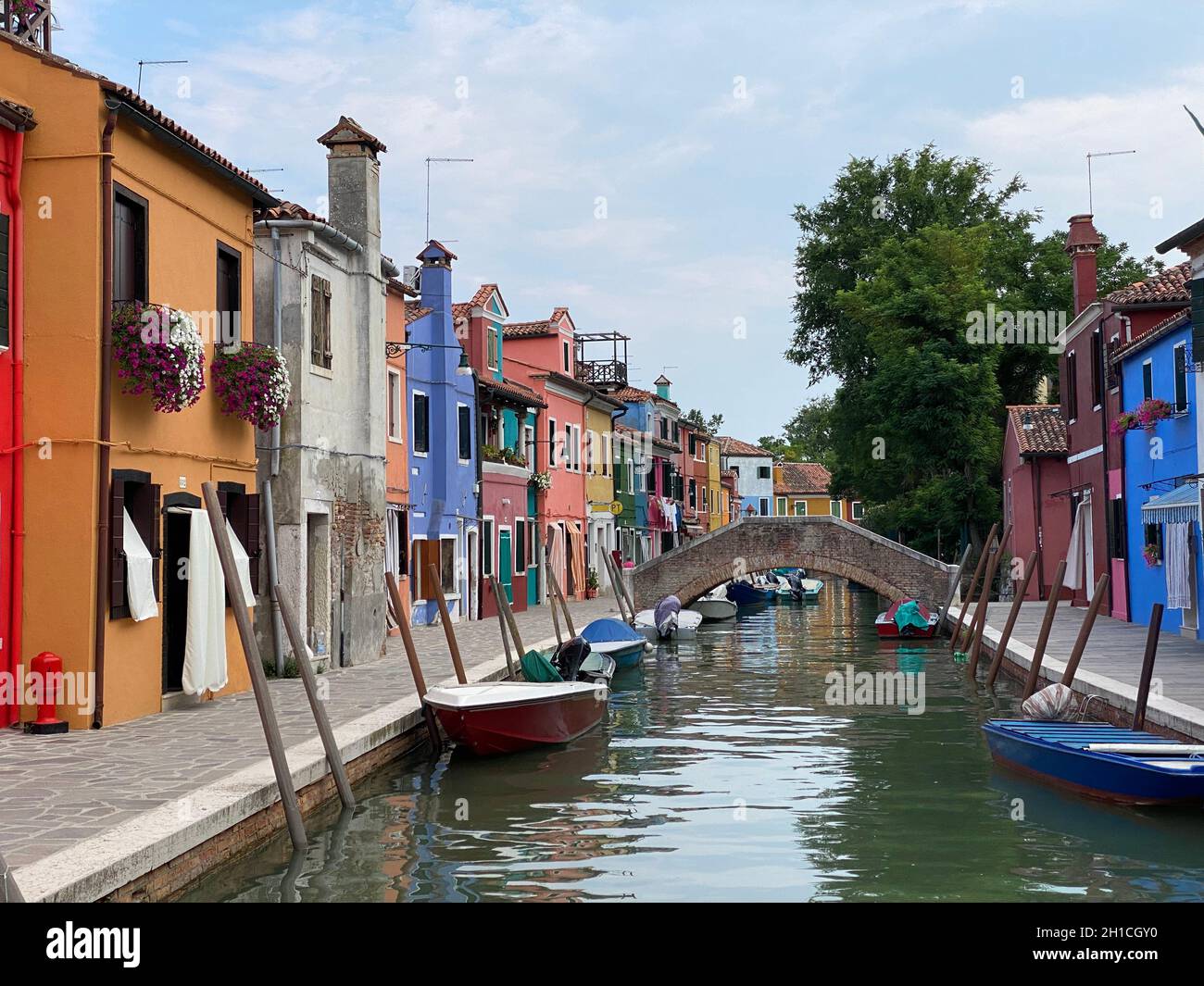 Boats and colorful traditional painted houses in a canal street houses ...