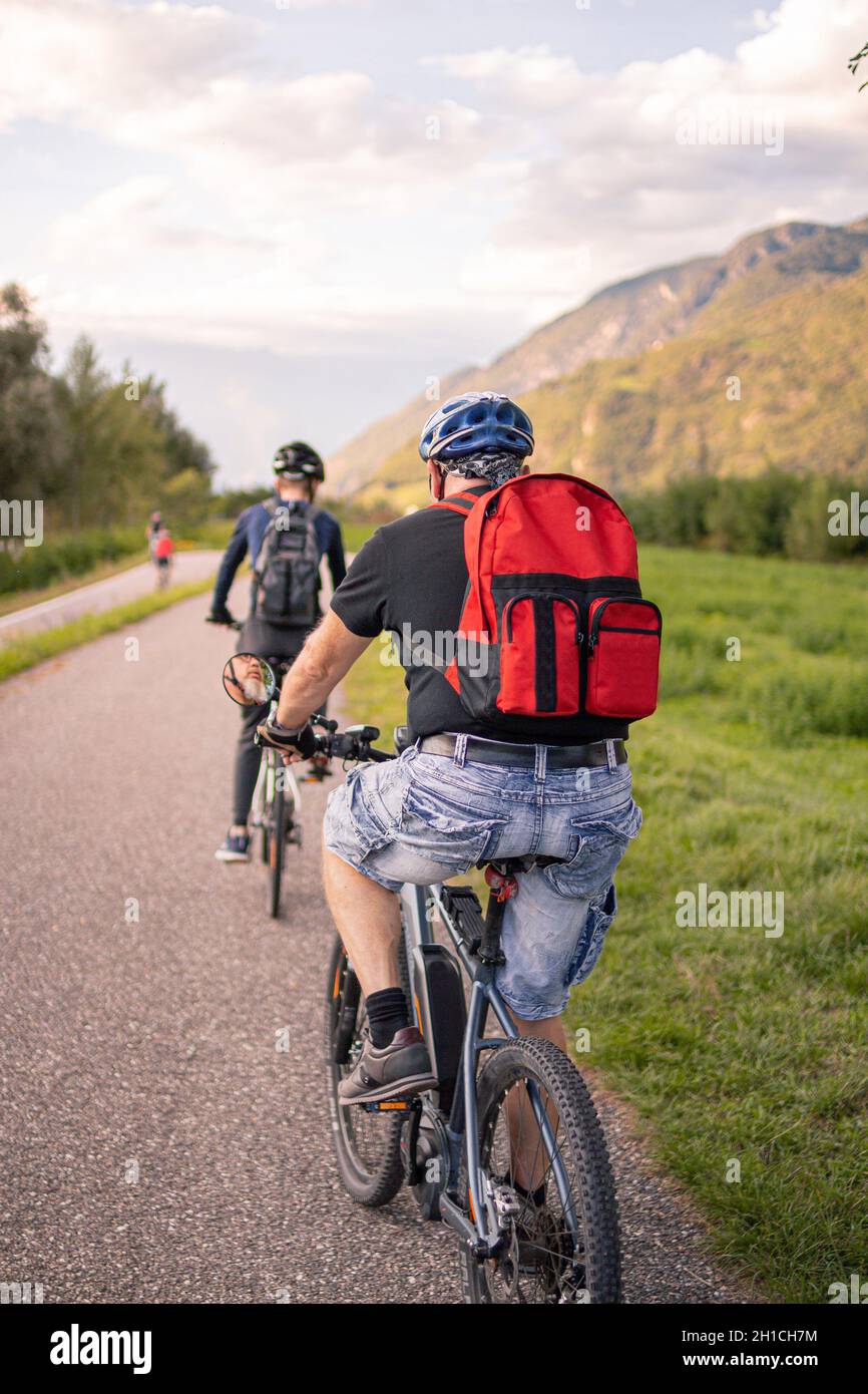 Father and son riding ebike and mountainbike on bikeway in Terlan