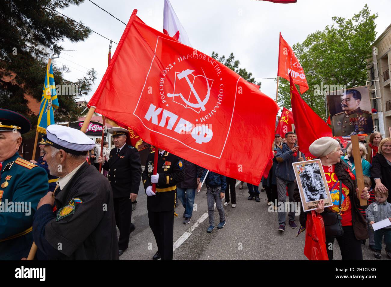 Anapa, Russia - May 9, 2019: The red flag of the Communist Party of the Russian Federation among the participants in the victory parade in Anapa Stock Photo