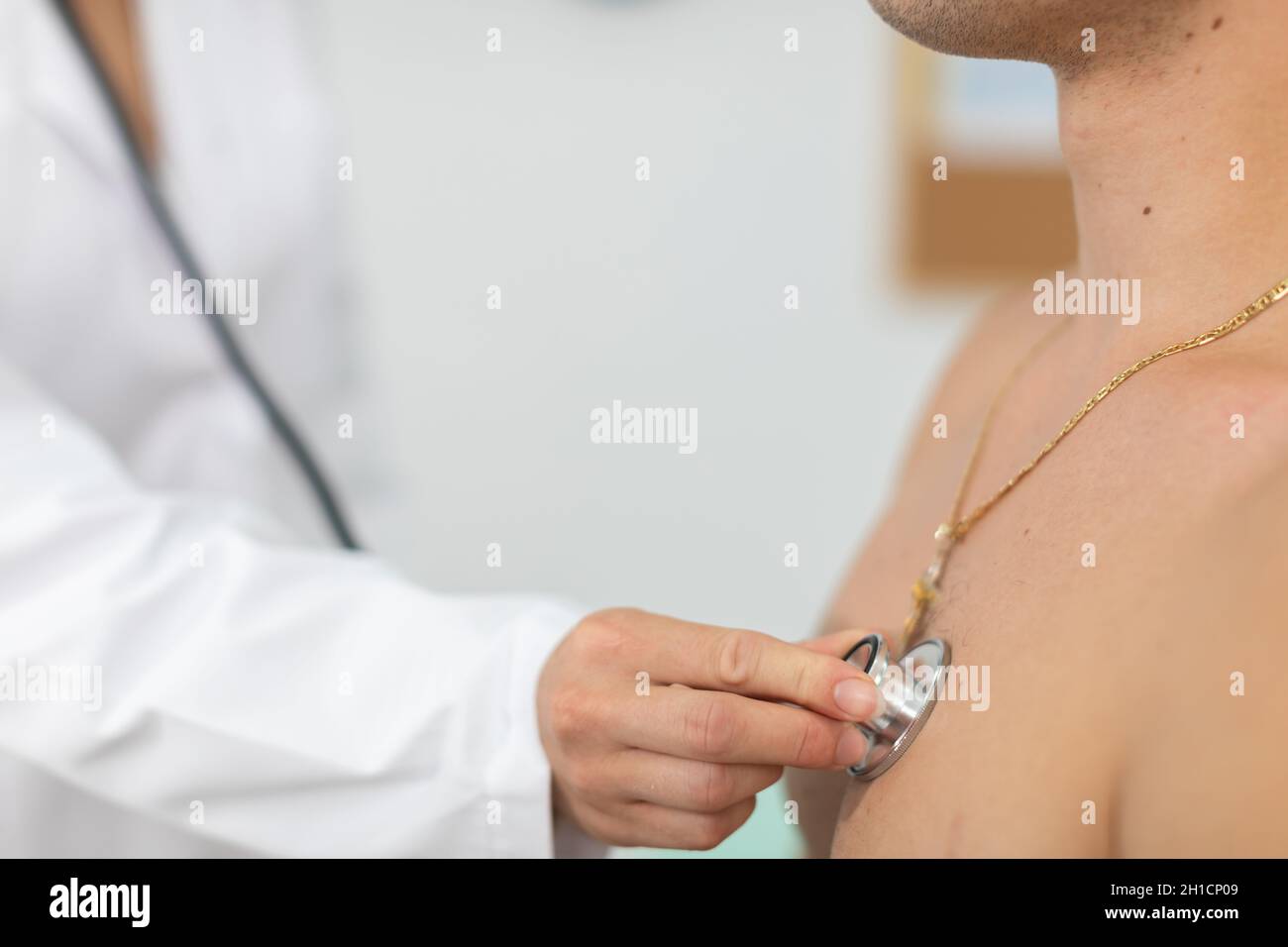 Your primary care physician checks a young athlete's lungs with a