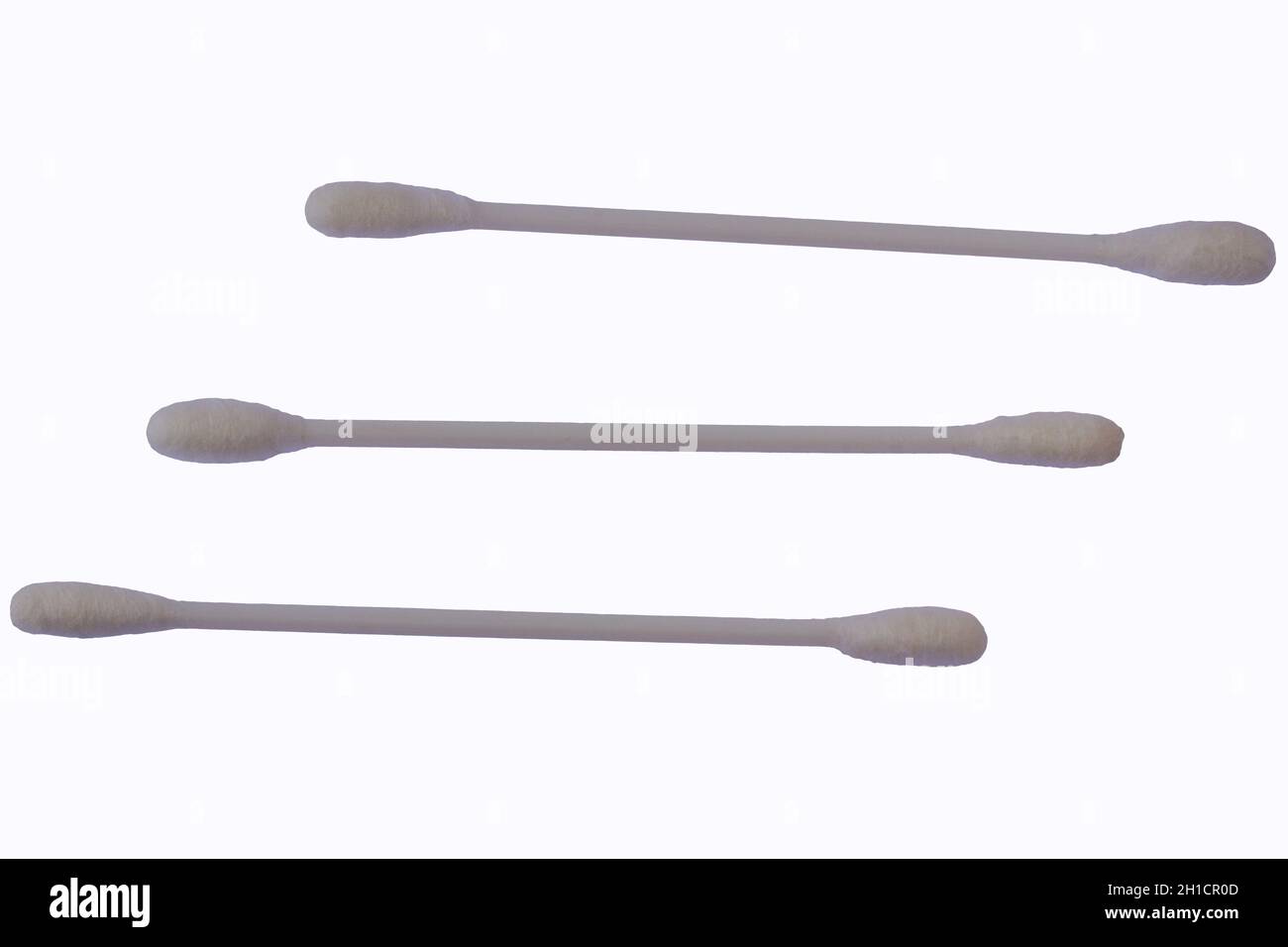 Three white cotton buds with plastic material isolated on a white background, for the theme of health, beauty, and cleanliness Stock Photo