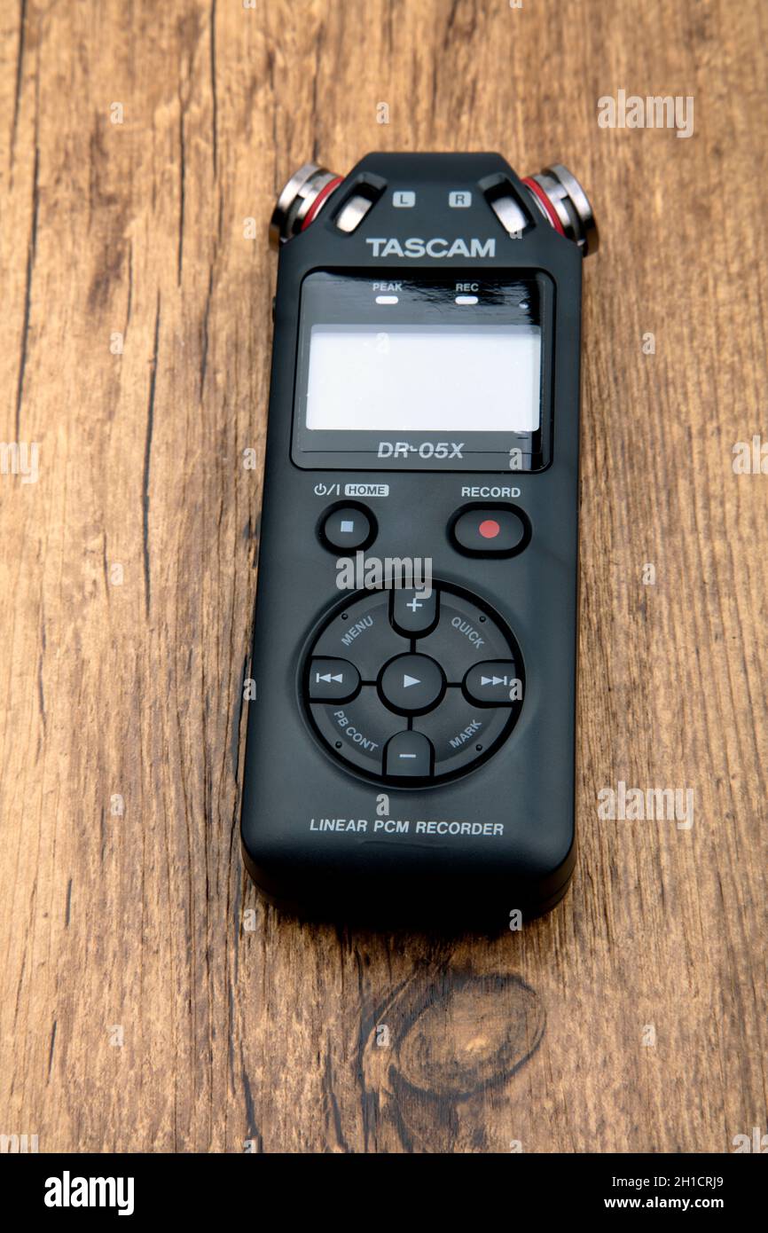 HUETTENBER, GERMANY - FEBRUARY 03, 2020: Tascam DR-05X Digital Audio recorder. Portable field recorder on wooden background. Stock Photo