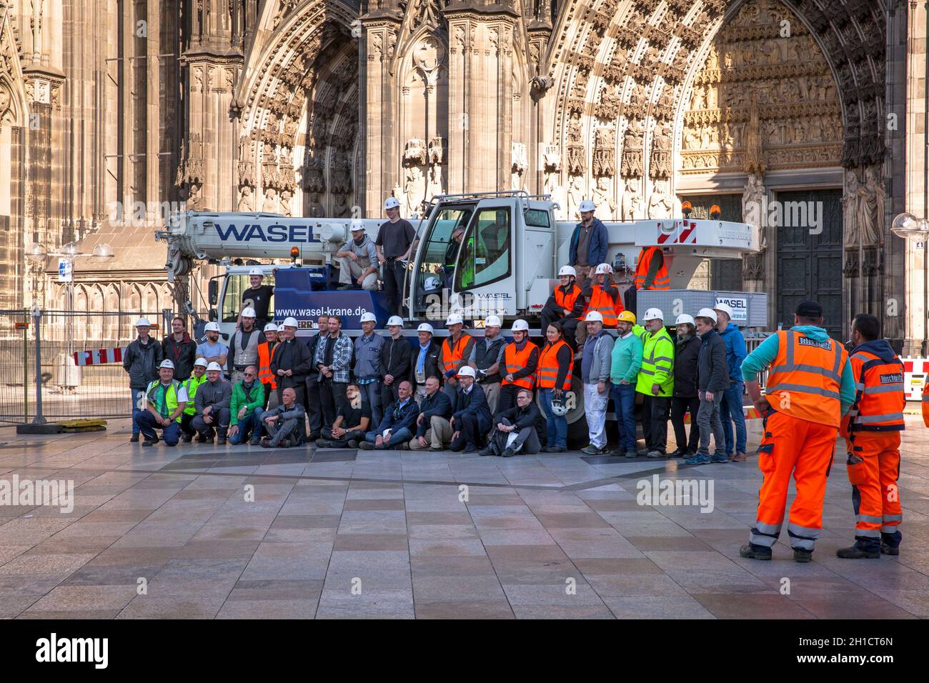 after the removing of a 30-meter-high scaffold, that hung for 10 years in 105 meters hight at the north tower of the cathedral, workers stand together Stock Photo