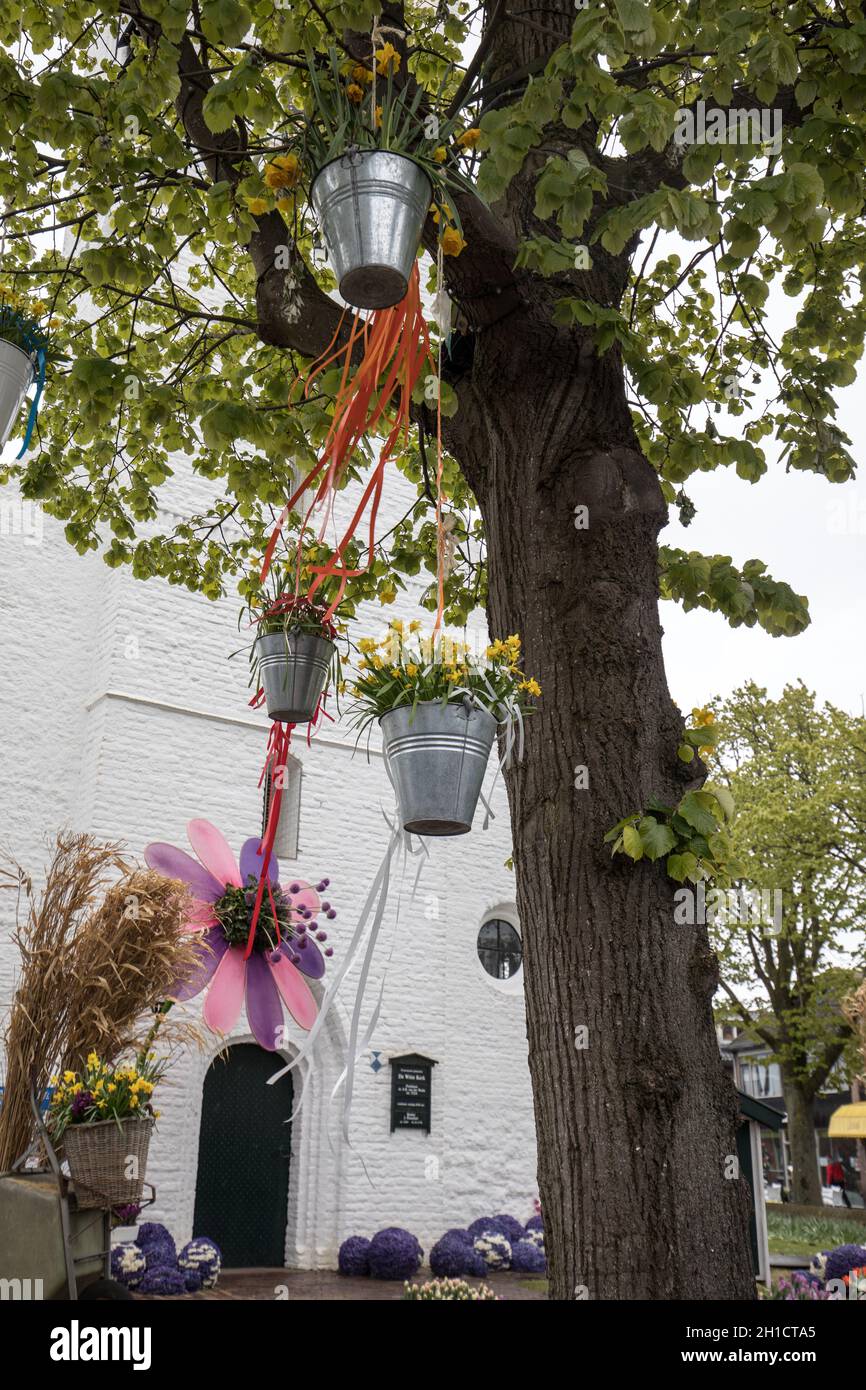 Noordwijkerhout, Netherlands - April 23,  2017: Decorations with hanging pails with yellow daffodils at the traditional flowers parade Bloemencorso fr Stock Photo