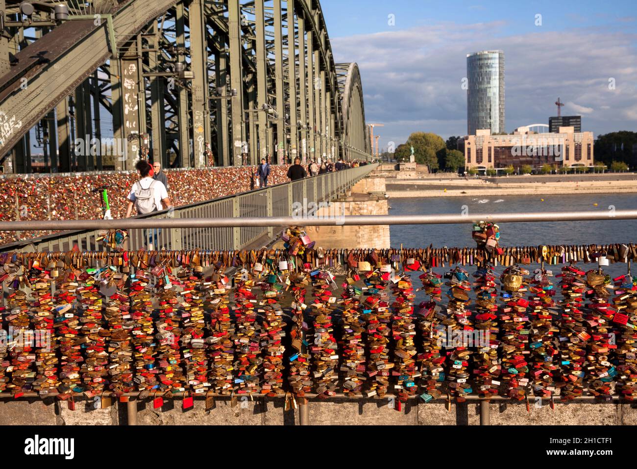 love locks at Hohenzollern Bridge, view over the Rhine to the KoelnTriangle skyscraper and the Hyatt Hotel in the Deutz district, Cologne, Germany.  L Stock Photo