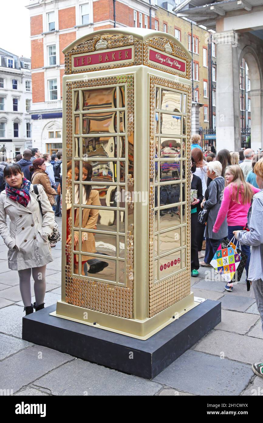 LONDON, UNITED KINGDOM - JUNE 23: Telephone booth in London on JUNE 23, 2012. Ted Baker Phone Box to celebrate ChildLine 25th anniversary at Covent Ga Stock Photo