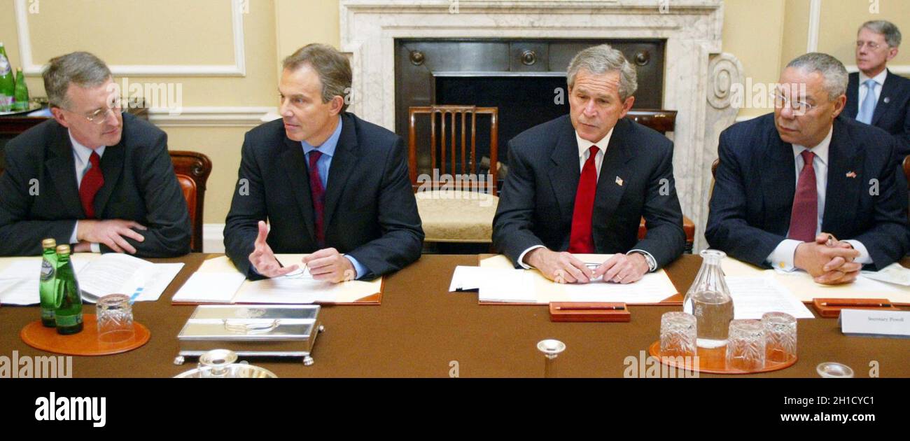 File photod ated 20/11/03 of the then US President George W. Bush (second right), taking part in round table discussion on HIV/AIDS with the then Prime Minister Tony Blair, (second left), the then Secretary of State for International Development Hilary Benn, (left), and US Secretary of State Colin Powell, (right), at 10 Downing Street in London.Colin Powell, the former US Joint Chiefs chairman and US secretary of state, has died from Covid-19 complications, his family has said. Issue date: Monday October 18, 2021. Stock Photo