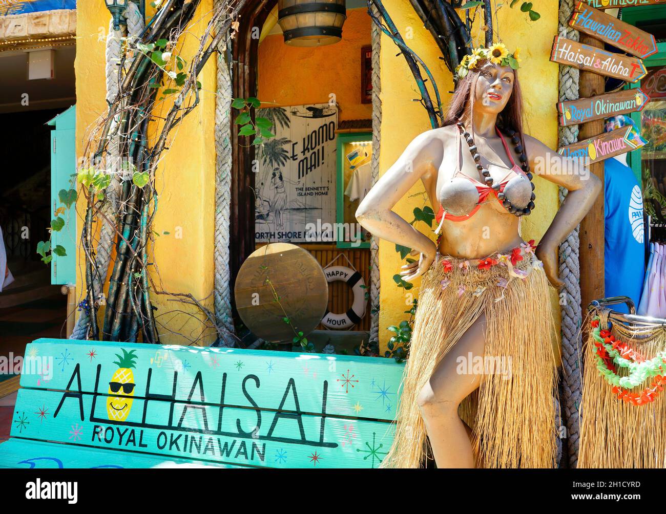 Mannequin doll of a tropical dancer wearing an hawaiian hula dancer grass skirt and a coconut bra in the shop mall of the American village of Chatan C Stock Photo