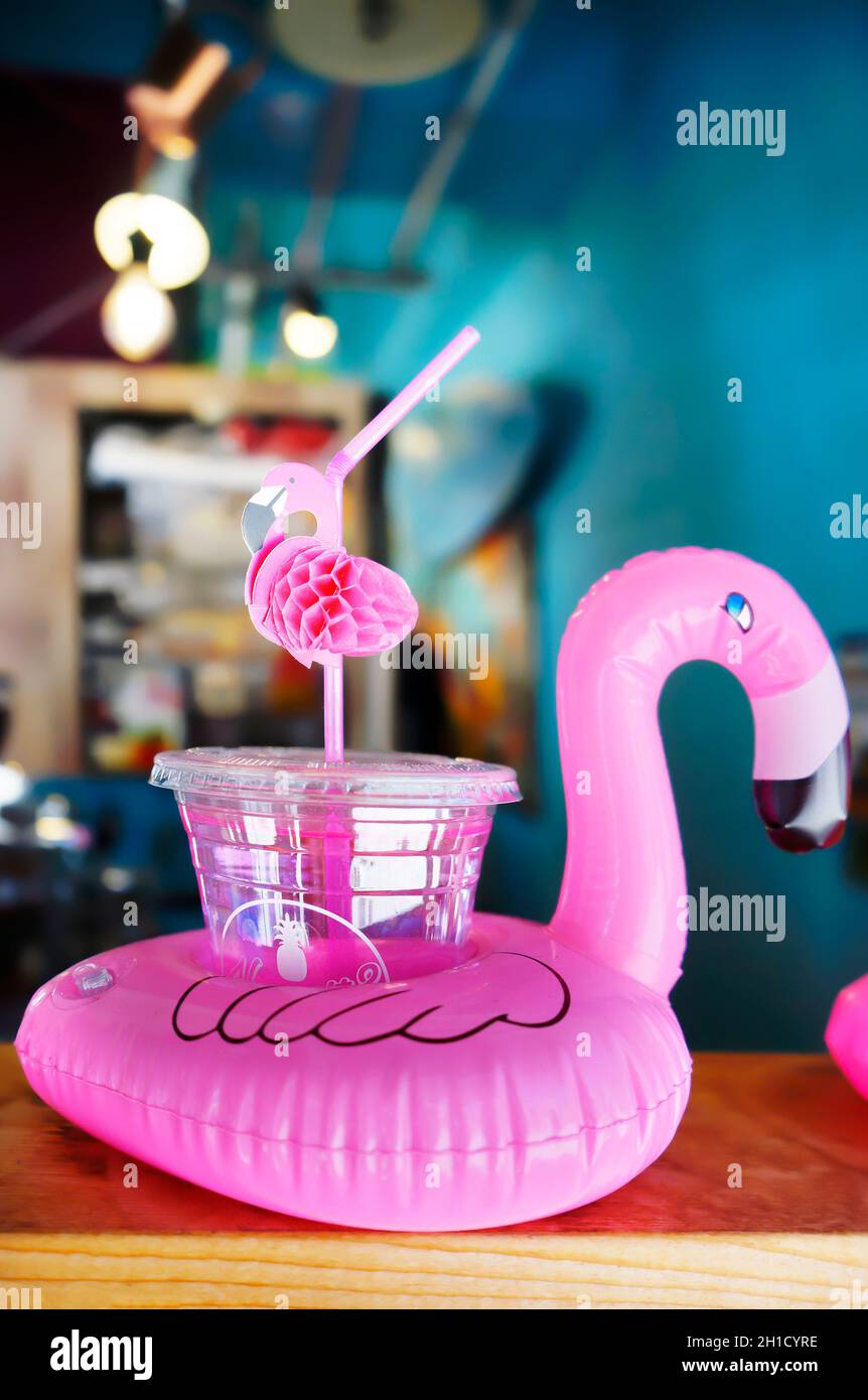 Cocktail glass with a flamingo-shaped straw and buoy on a bar counter in Mihama Town Resort American Village Stock Photo