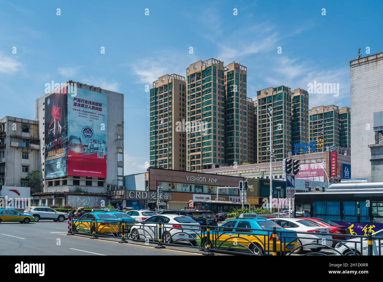 Yichang, China - August 2019 : Row of cars waiting on a green light on a busy crossroad on a hot summerday in Yichang town, Hubei Province Stock Photo