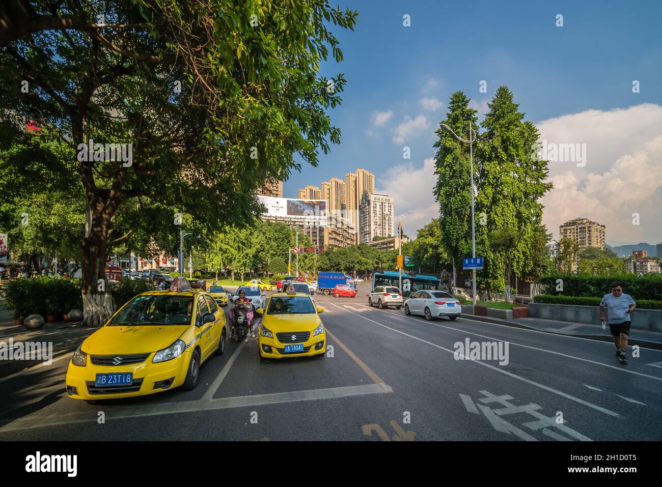 Chongqing, China - August 2019 : Yellow taxis driving on the busy and congested city streets Stock Photo