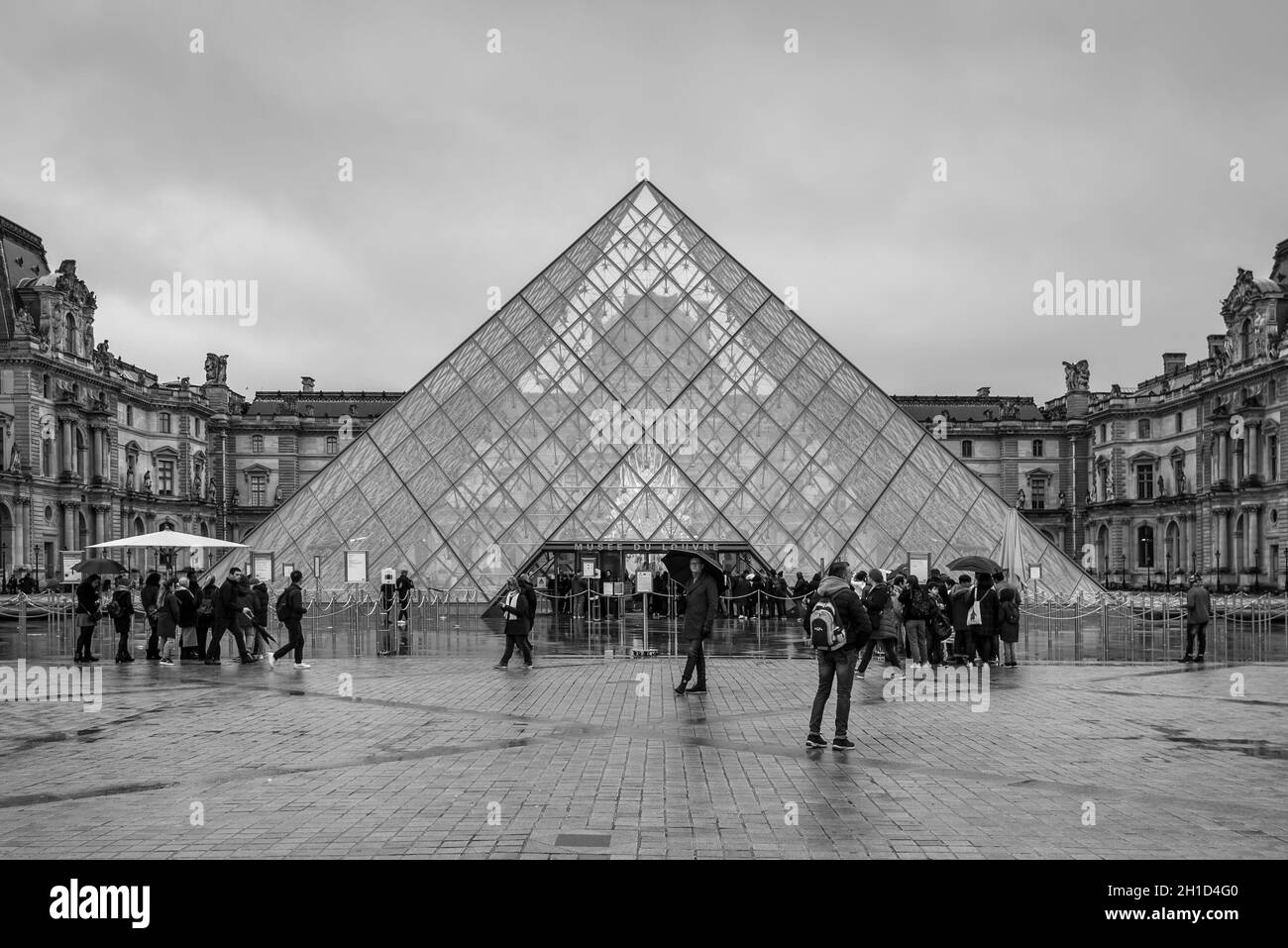 Paris, France - December 23, 2018: Louvre museum with glass pyramid in Paris, France. It is one of the top tourist attractions of Paris. Paris landmar Stock Photo