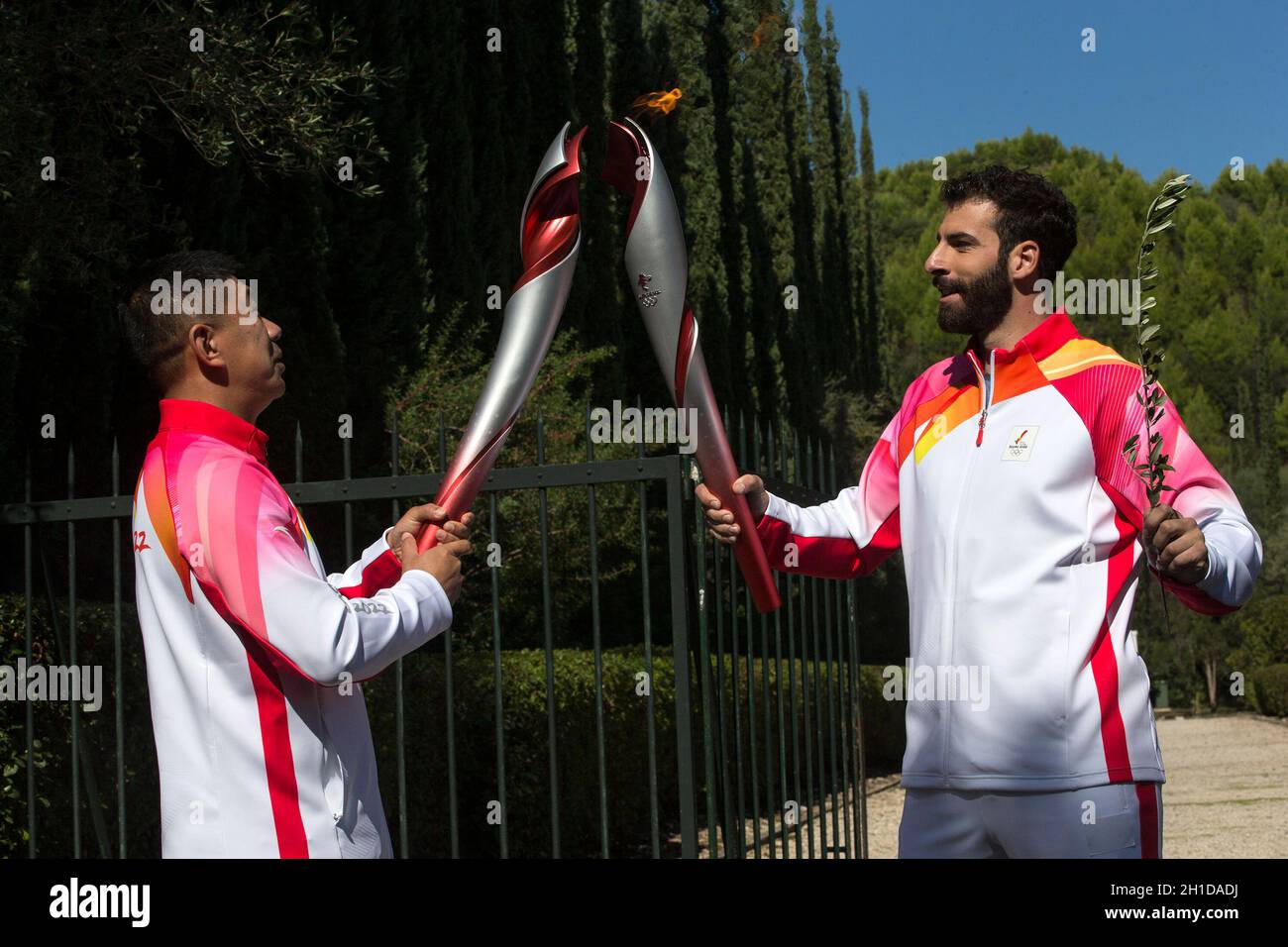 Ancient Olympia, Greece. 18th Oct, 2021. The first torchbearer, Greek  alpine ski racer Ioannis Antoniou (R) passes the flame to the second  torchbearer, Li Jiajun, who is also a former Chinese short