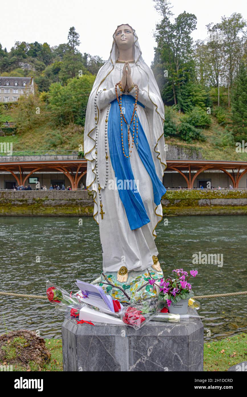 Lourdes, France - 9 Oct 2021: A statue of the Virgin Mary on the banks of the Gave de Pau river in Lourdes Stock Photo