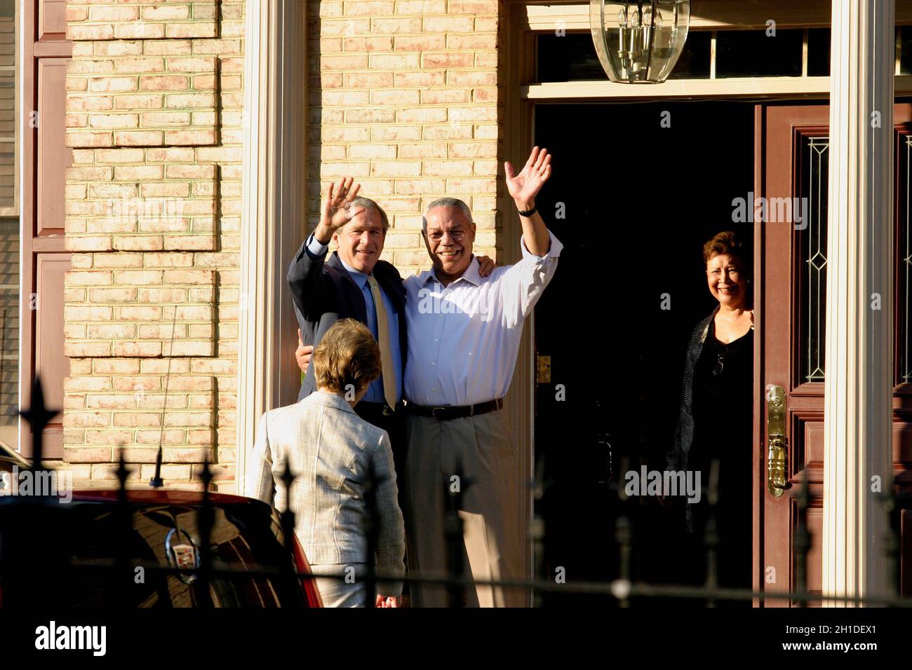 McLean, VA - May 31, 2005 -- On short notice, United States President George W. Bush and first lady Laura Bush went to the home of former Secretary of State Colin L. Powell and his wife Alma. Powell was dressed in a light-colored dress shirt and khakis (no jacket or tie). The President embraced him and, turning to wave at the cameras, removed his suit jacket and grinned. The first lady wore a light-colored pantsuit. The dinner was private, with just the two couples. Credit: Martin H. Simon - Pool via CNP Stock Photo