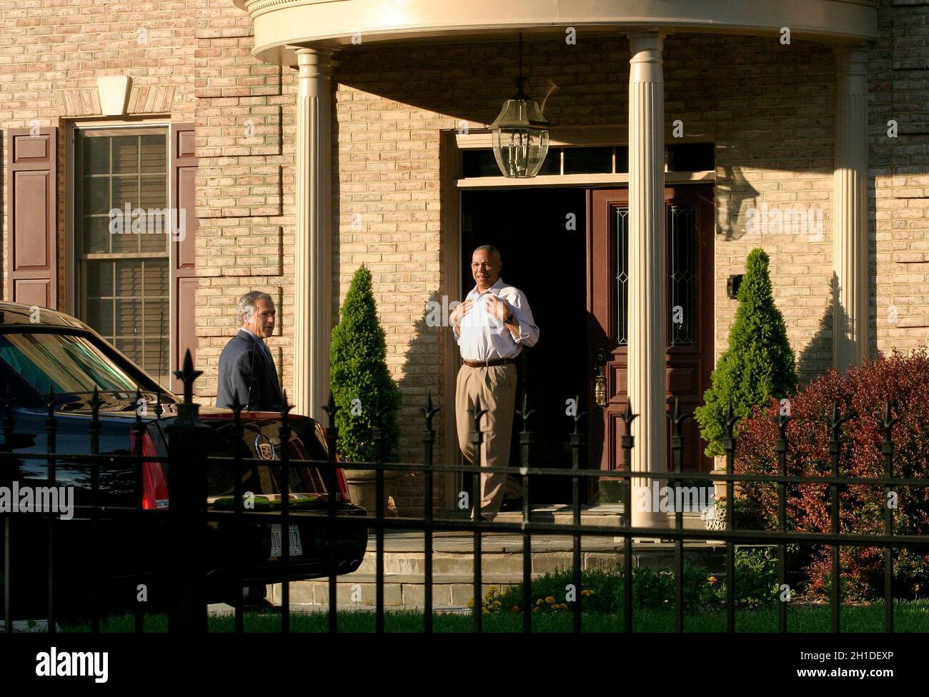 McLean, VA - May 31, 2005 -- On short notice, United States President George W. Bush and first lady Laura Bush went to the home of former Secretary of State Colin L. Powell and his wife Alma. Powell was dressed in a light-colored dress shirt and khakis (no jacket or tie). The President embraced him and, turning to wave at the cameras, removed his suit jacket and grinned. The first lady wore a light-colored pantsuit. The dinner was private, with just the two couples. Credit: Martin H. Simon - Pool via CNP Stock Photo
