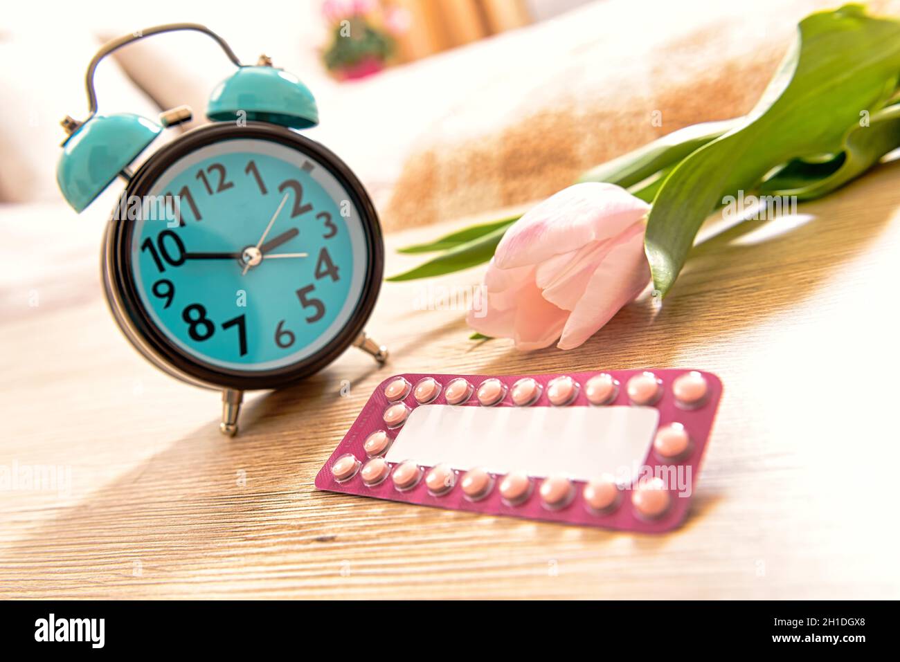 Birth control pills and  clock, remember to take the contraceptive pill Stock Photo