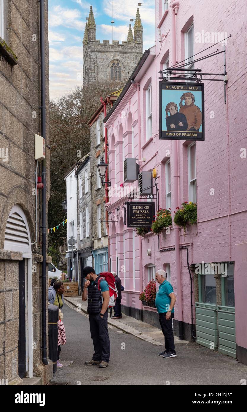 Fowey Cornwall street scene - people in the street on a summer evening outside the King of Prussia Hotel, Fowey, Cornwall UK Stock Photo