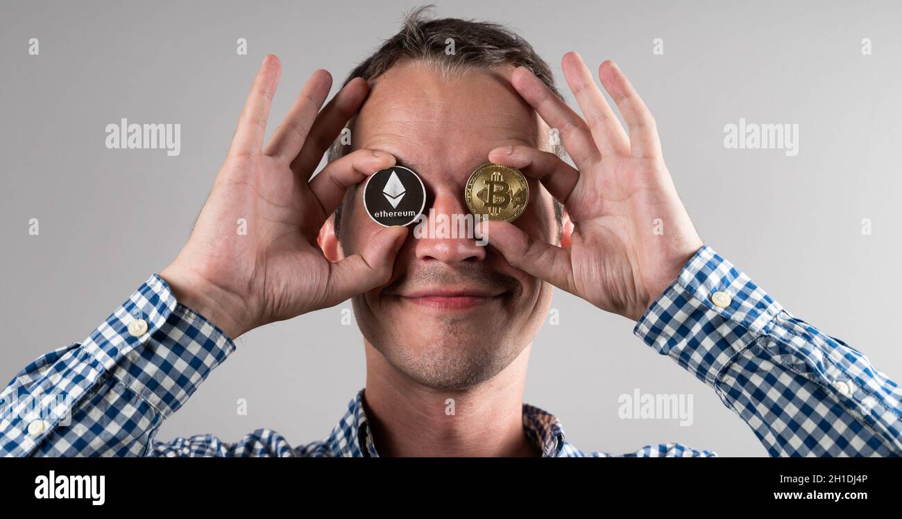 A man is holding a cryptocurrency.  Stock Photo