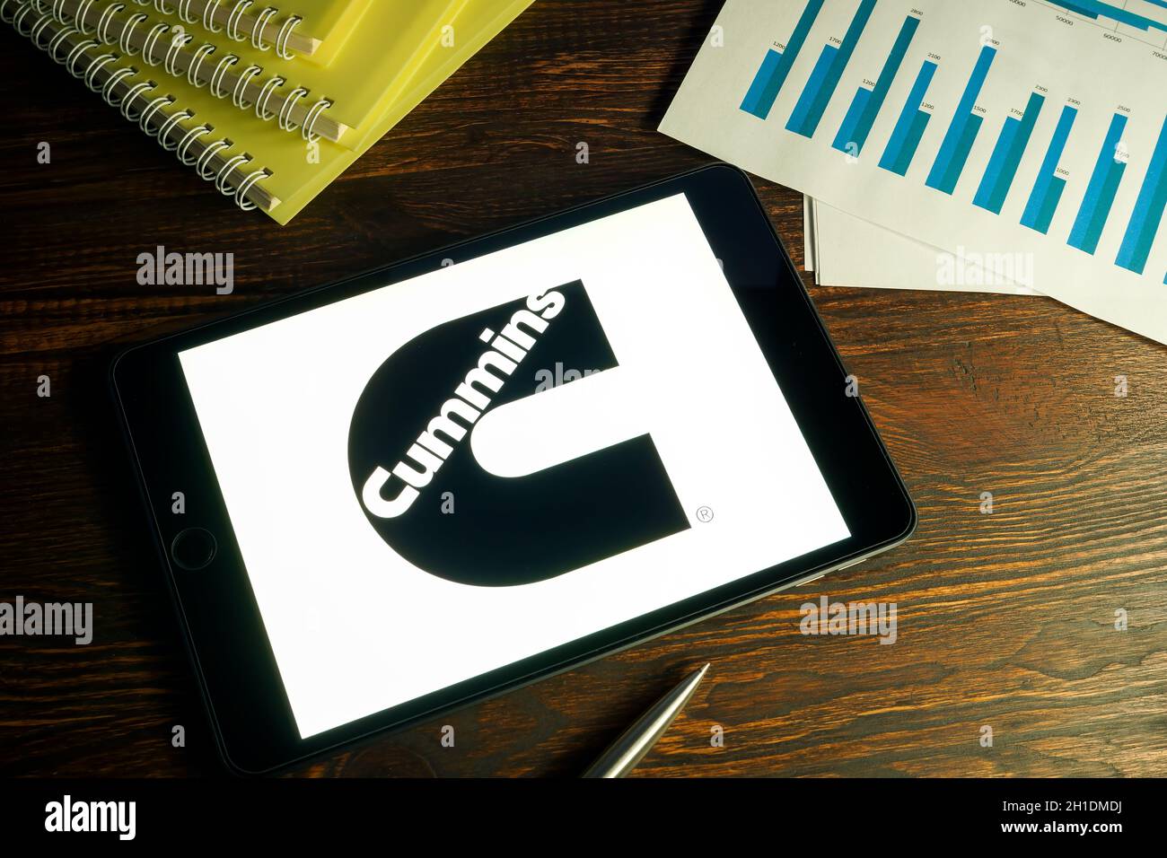 KYIV, UKRAINE - August 21, 2021. Tablet with Cummins company logo and business papers. Stock Photo