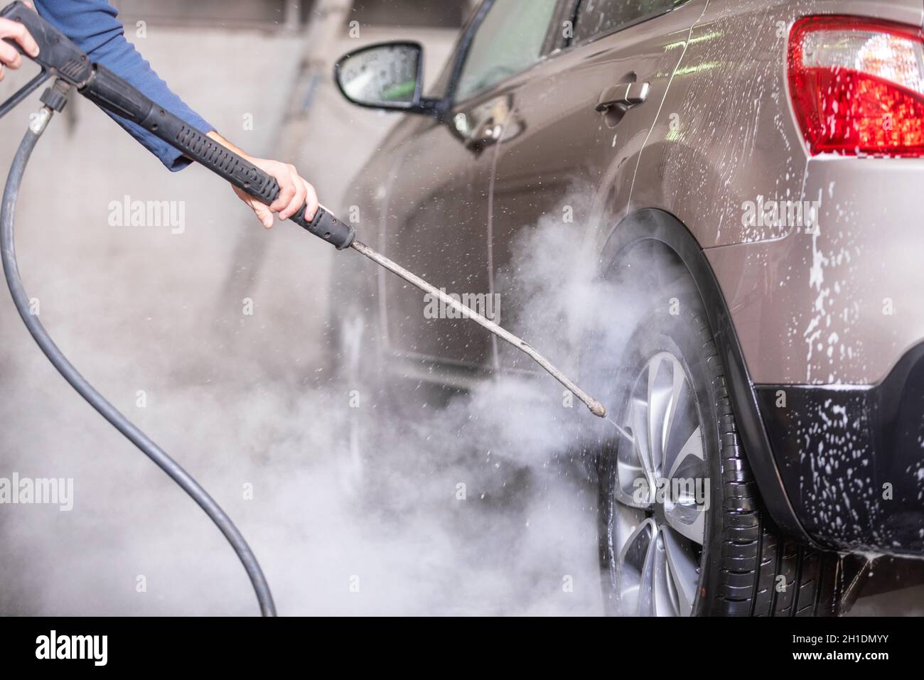 Manual car wash with pressurized water in car wash outside Stock Photo
