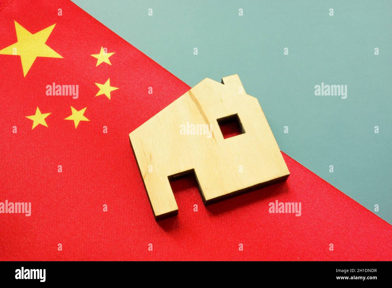 China flag and house model as a symbol of the developers or construction industry. Stock Photo