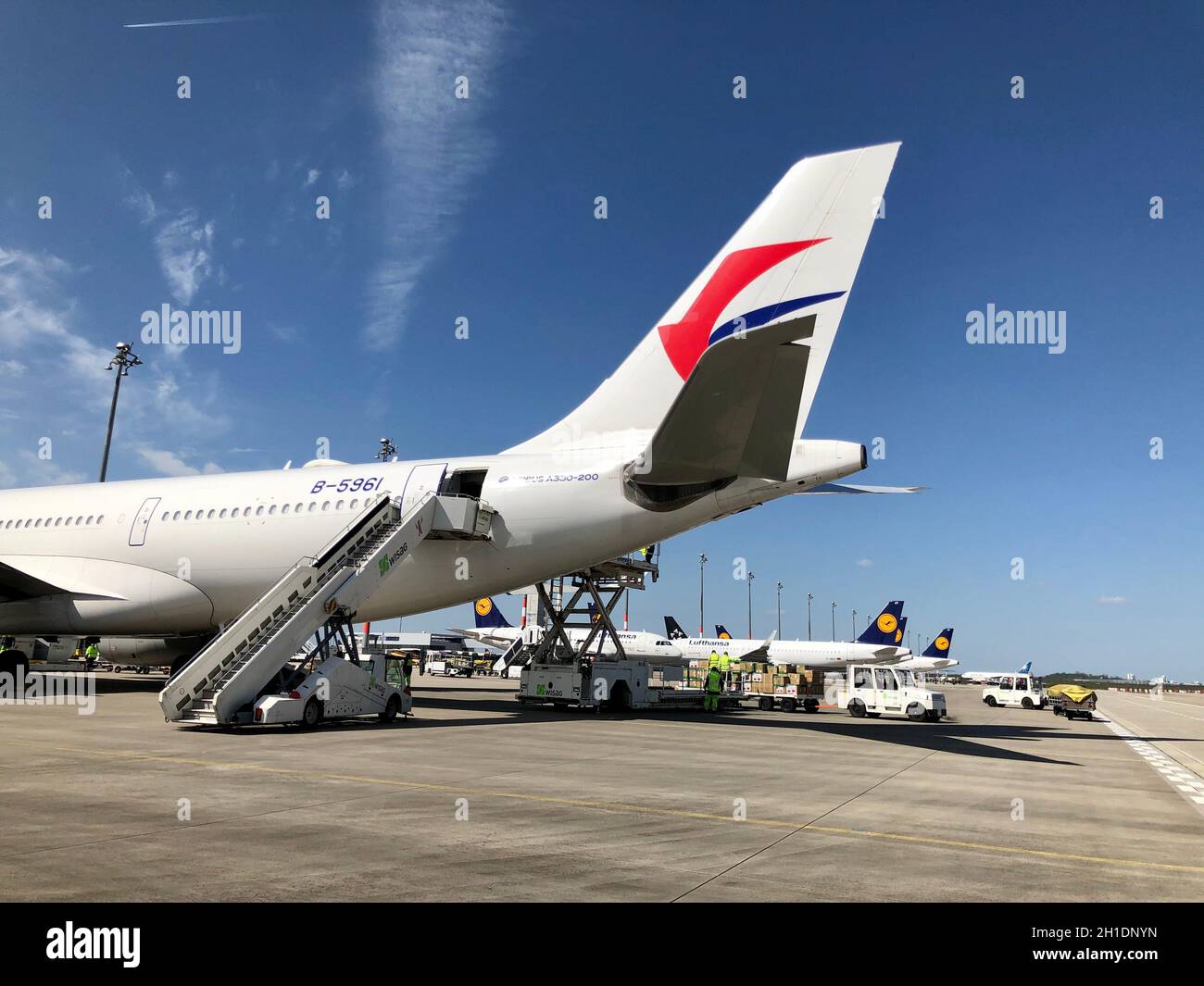 Around 12:00 p.m., an Airbus A330-200 from China Eastern landed at Berlin-Brandenburg Airport to probably deliver a larger load with the urgently need Stock Photo